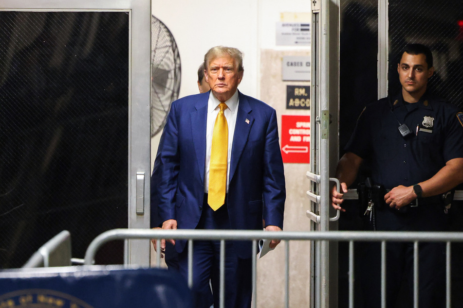 Former President Donald Trump (l.) returns to the courtroom after a break in his trial for allegedly covering up hush money payments at Manhattan Criminal Court on Thursday in New York City.