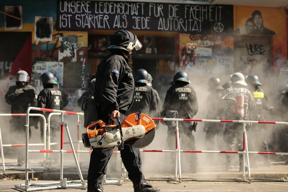 Polizisten öffnen die Tür zu "Rigaer 94" in der Rigaer Straße in Berlin-Friedrichshain mit schwerem Gerät, um eine Brandschutzprüfung durchführen zu lassen.