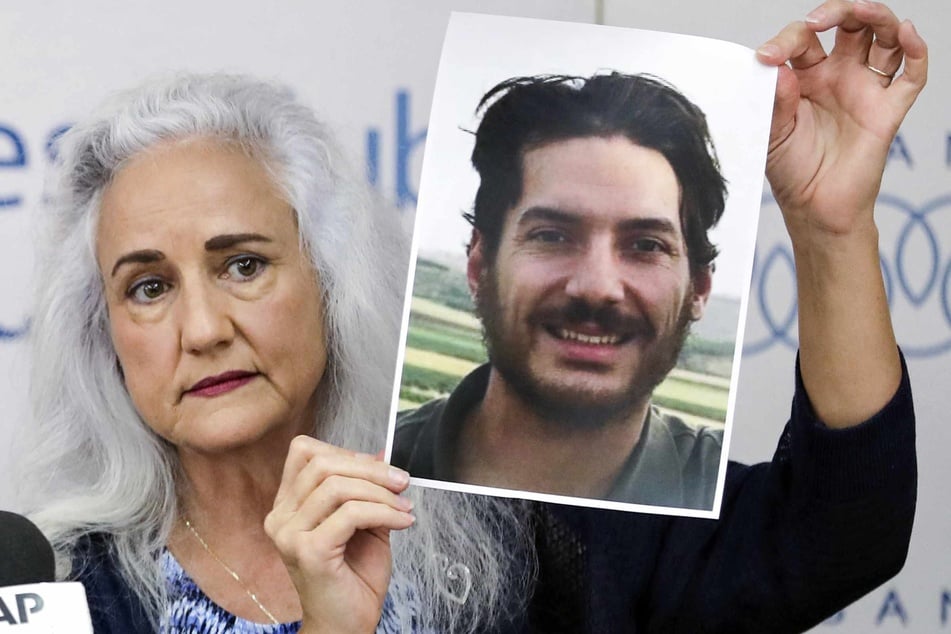 Debra Tice, mother of US journalist Austin Tice who was kidnapped in Syria five years prior, holds a dated portrait of him during a press conference in the Lebanese capital Beirut on July 20, 2017.