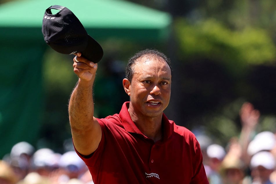 Tiger Woods acknowledges the crowd on the green on the 18th hole after completing his final round at the Masters in Augusta, Georgia, on April 14, 2024.