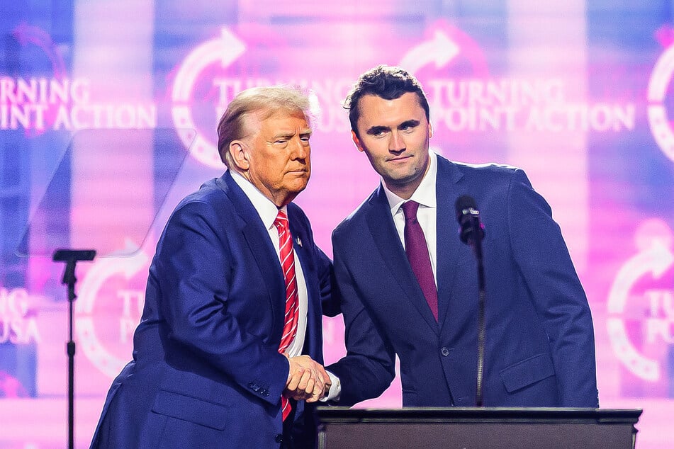 President Donald Trump and Charlie Kirk (r.) shaking hands during a Turning Point USA event in Phoenix, Arizona on December 22, 2024.