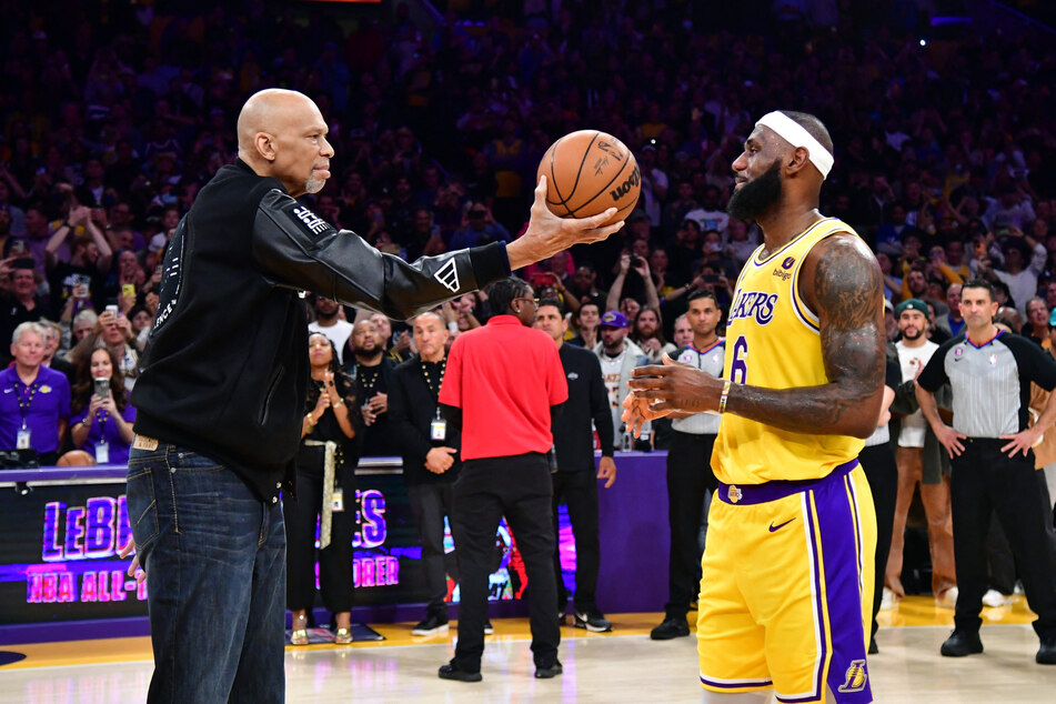 Kareem Abdul-Jabbar joined LeBron James on the court to mark the LA Lakers star's record-breaking points haul.