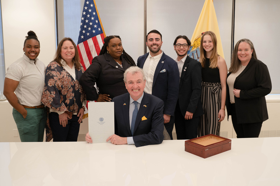Governor Phil Murphy (c.) has signed an executive order to protect access to gender-affirming care in New Jersey.