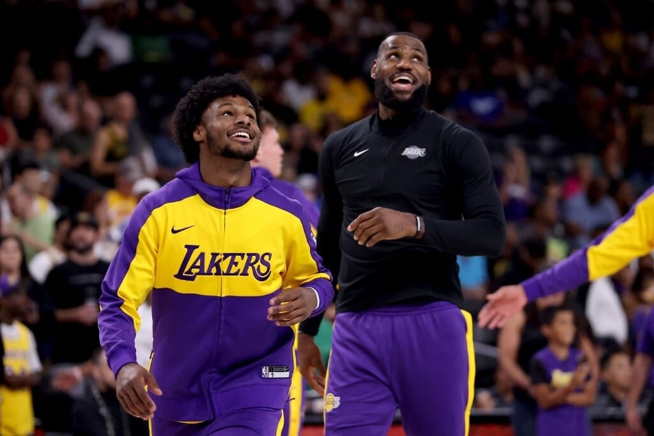 Bronny James (l.) and LeBron James of the Los Angeles Lakers warm up prior to the game against the Phoenix Suns at Acrisure Arena.