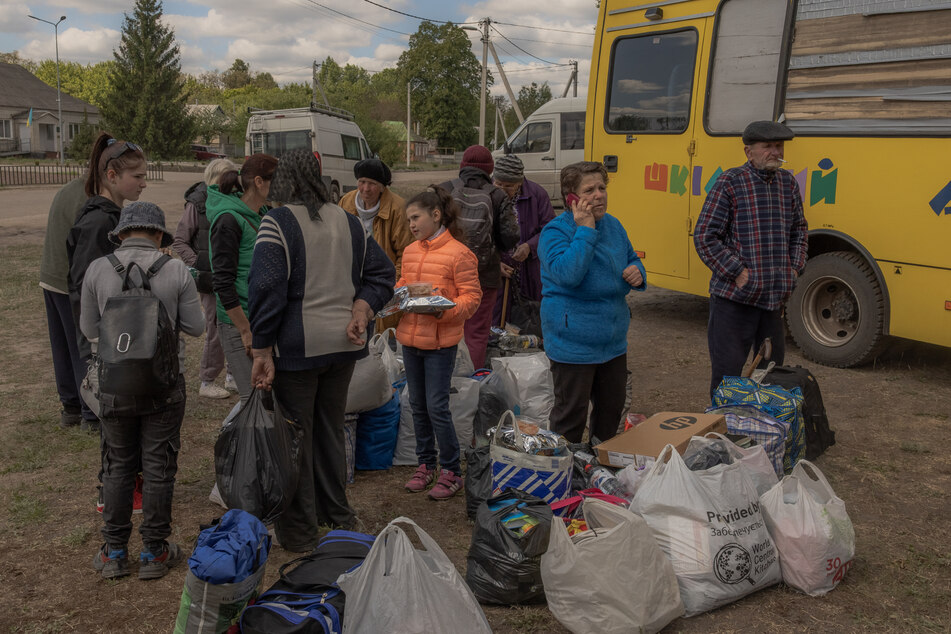 Evacuees from the town of Vovchansk arrive at an evacuation point in Kharkiv region.