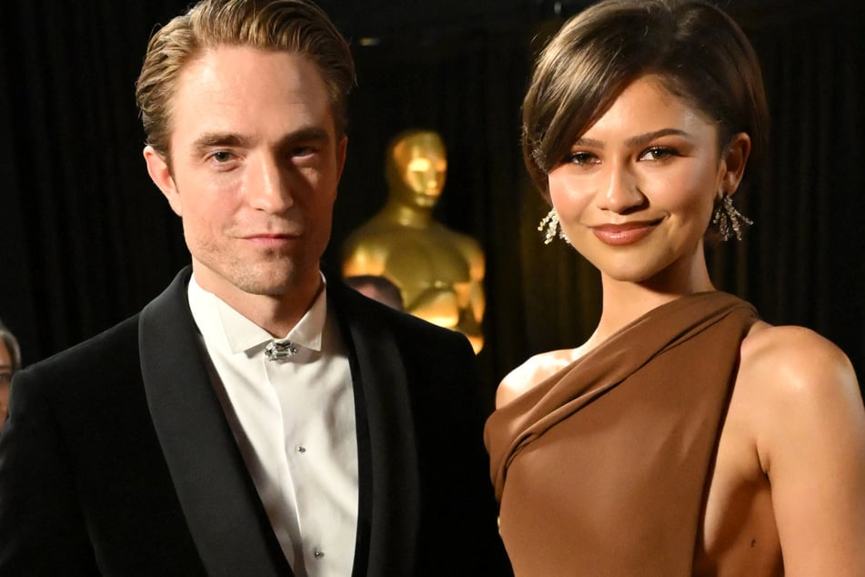 Fans spotted Zendaya's (r.) "t" tattoo on her left side as she presented at the 2026 Oscars alongside Robert Pattinson.