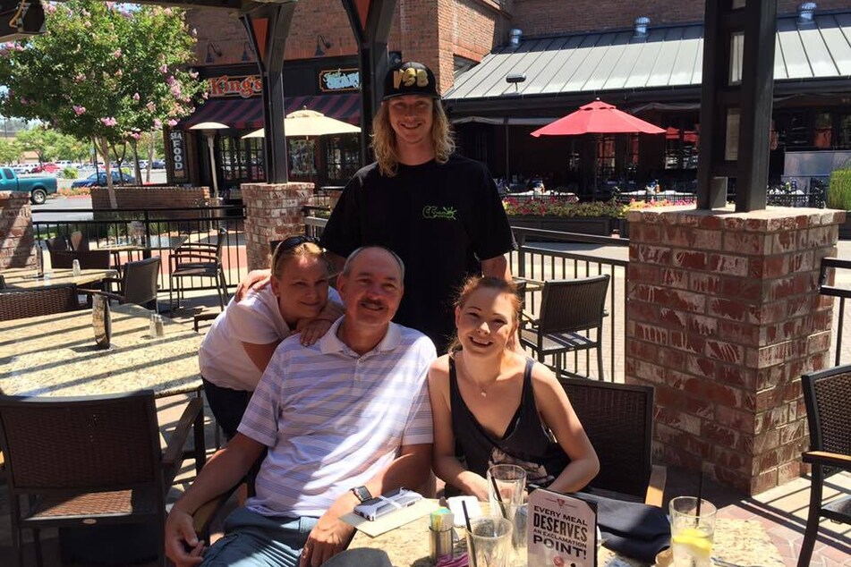 Andreas Probst (c.), who was run down and killed while riding his bicycle, enjoys a Father's Day meal with his family.