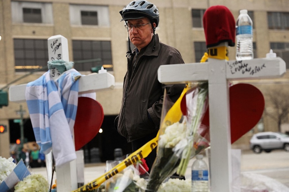 Mark Hennen, who narrowly missed being hit by Saipov's truck and only survived by swerving onto a path moments before, looks at the eight crosses honoring those whose lives were lost.