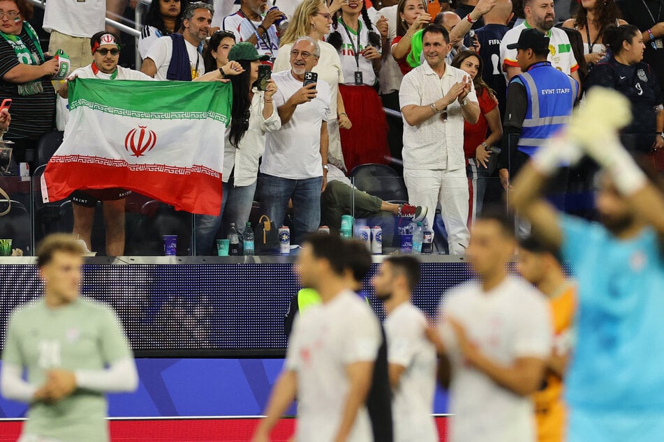 An Iran fan displays their national flag inside the stadium after the team's World Cup Group G match against New Zealand.