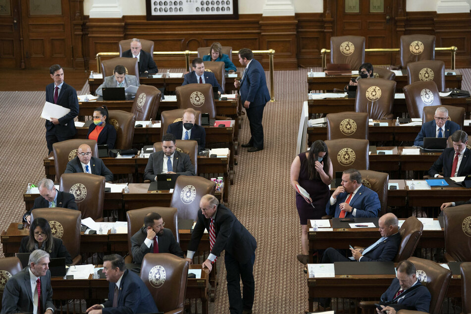 Texas House members confer as they consider HB1, the state's redistricting bill.