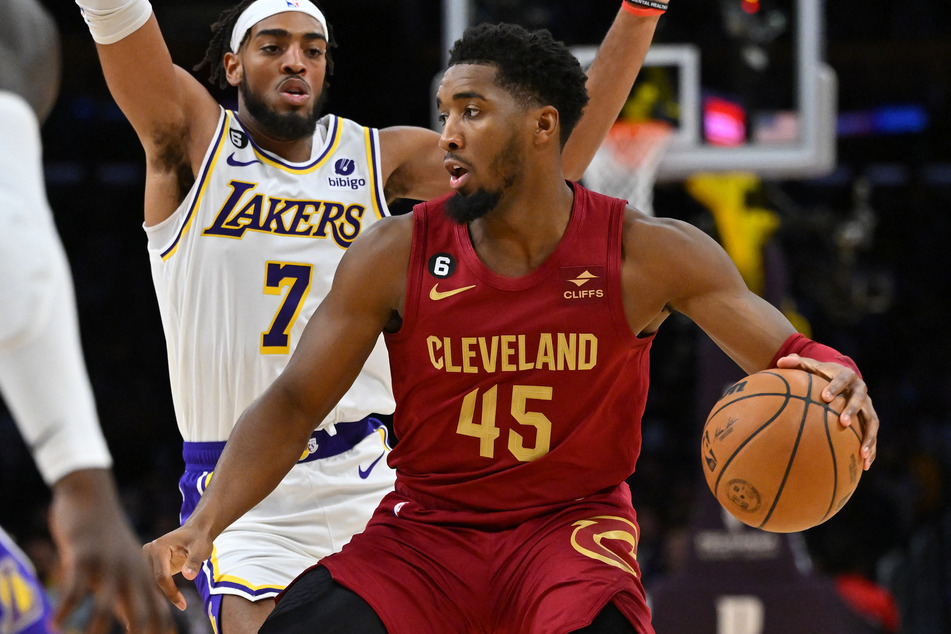 Los Angeles Lakers forward Troy Brown Jr. defends Cleveland Cavaliers guard Donovan Mitchell as he drives to the basket in the first half at Crypto.com Arena.