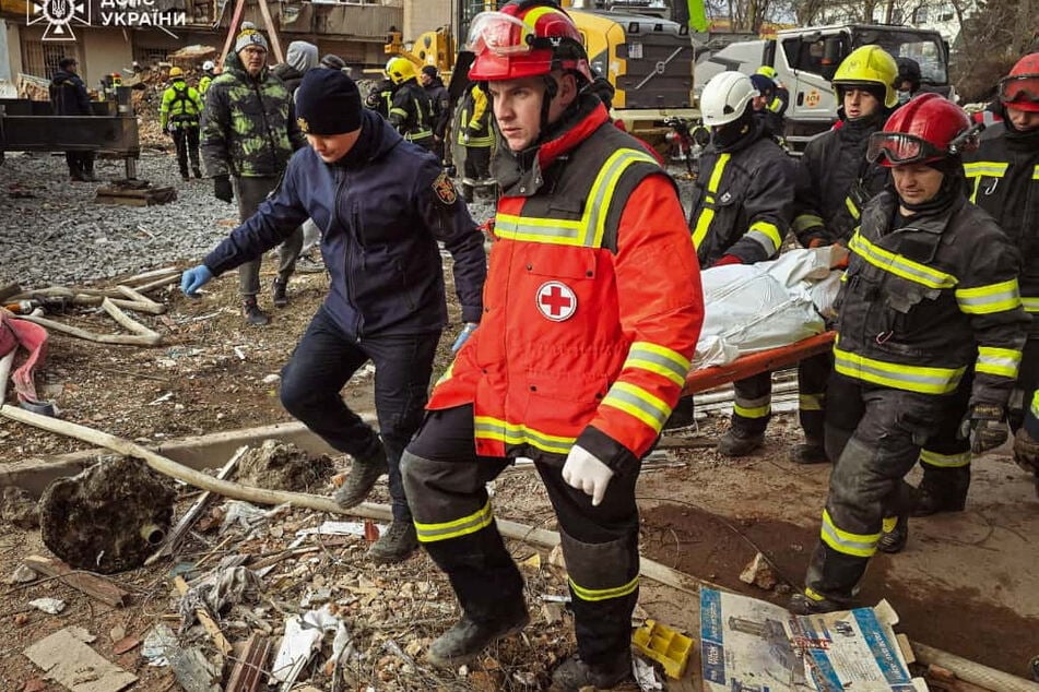Emergency responders continued to work to rescue and recover people trapped beneath the rubble of damaged residential buildings.