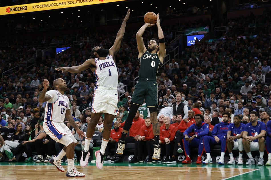Boston Celtics forward Jayson Tatum shoots past Philadelphia 76ers guard James Harden during the third quarter at TD Garden.