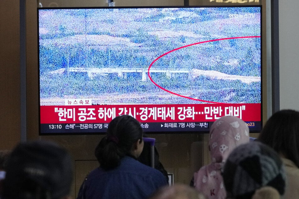 A TV screen reports that North Korea has blown up parts of the northern side of the inter-Korean roads.