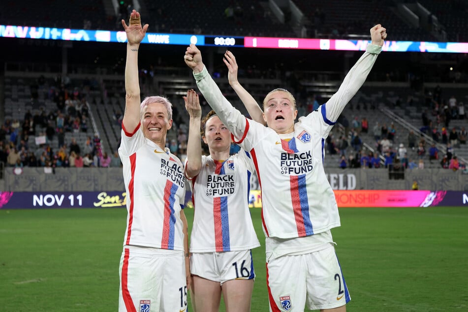 OL Reign forward Megan Rapinoe, midfielder Rose Lavelle, and defender Emily Sonnett celebrate after defeating the San Diego Wave FC in the NWSL championship semifinal.