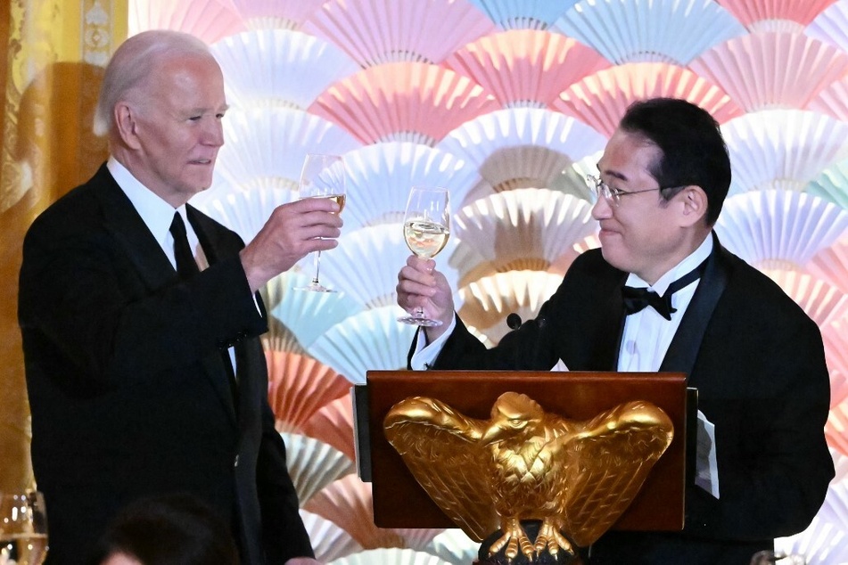 US President Joe Biden (l.) and Japanese Prime Minister Fumio Kishida raise glasses in a toast during a State Dinner in the East Room of the White House on April 10, 2024.