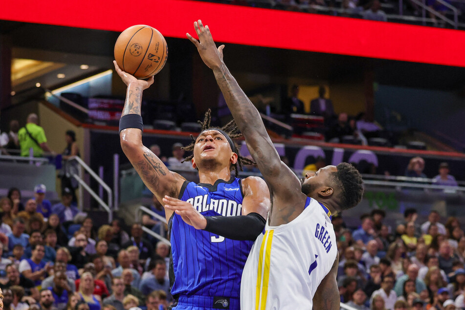 Orlando Magic forward Paolo Banchero goes to the basket against Golden State Warriors forward JaMychal Green during the second half at Amway Center.