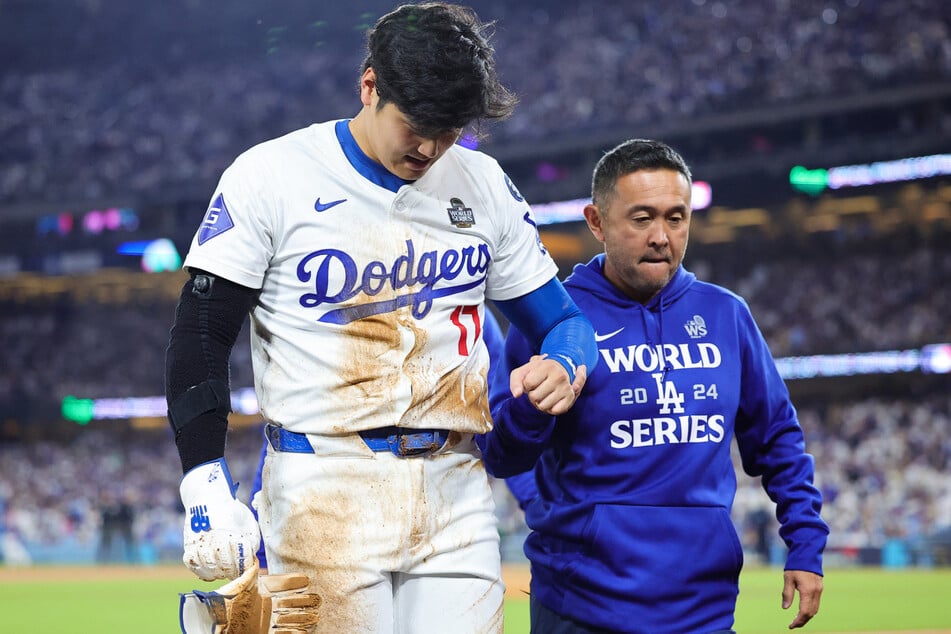 Shohei Ohtani (l.) has been diagnosed with a "little left shoulder subluxation" after he attempted to steal second base in the seventh inning of Saturday's game.