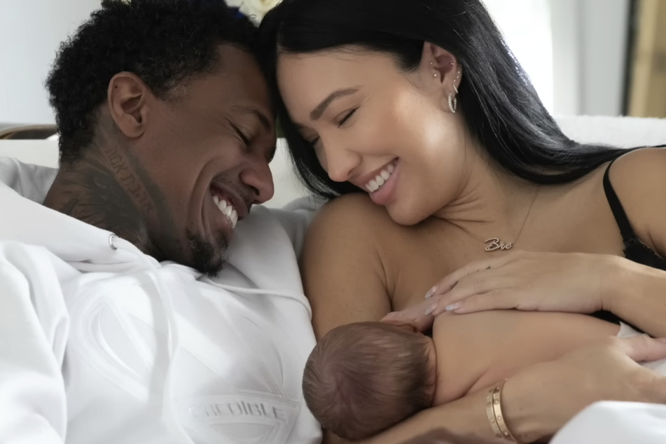 Nick Cannon and Bre Tiesi holding their newborn son Legendary for the first time.