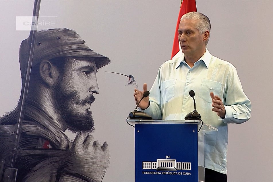 Screen grab from footage broadcast by Cuban official TV on March 13, 2026, shows Cuba's President Miguel Diaz-Canel speaking next to an image of late Cuban leader Fidel Castro.