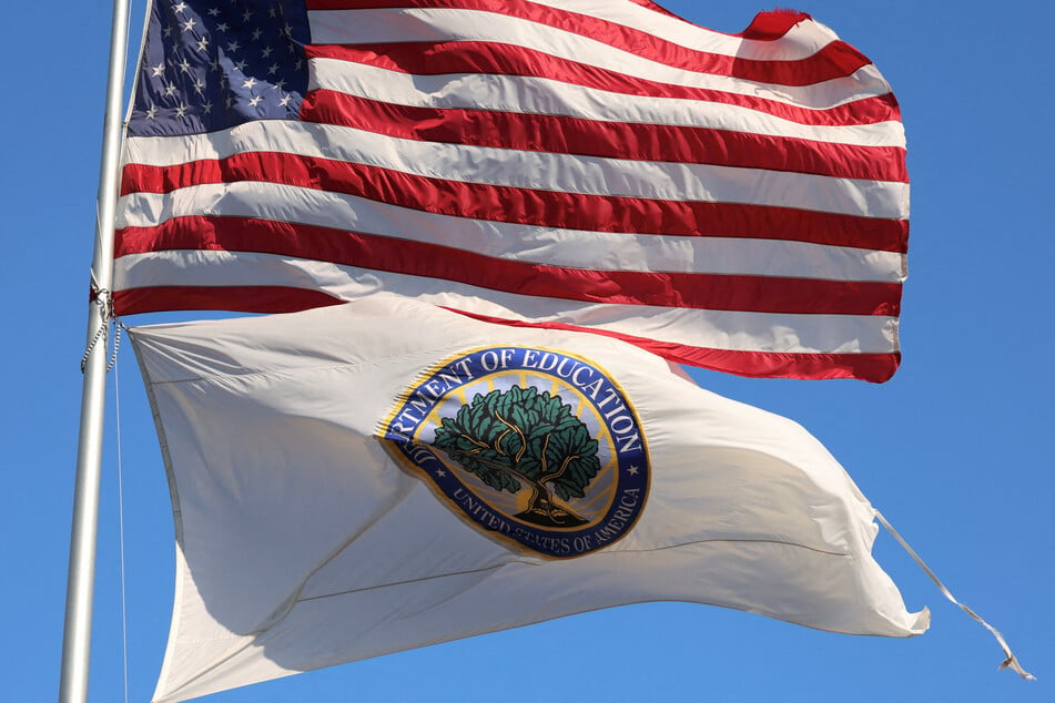 An American flag and a tattered US Department of Education flag fly outside the federal office building in Washington DC.