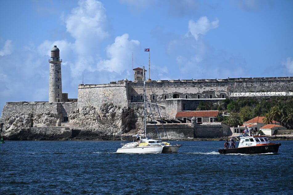 This view shows one of the two sailboats (L) carrying humanitarian aid that had previously gone missing arriving at the port of Havana on Saturday.