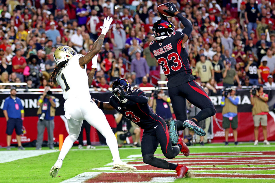 Arizona Cardinals cornerback Antonio Hamilton intercepts a pass intended for New Orleans Saints wide receiver Marquez Callaway during the first quarter at State Farm Stadium.
