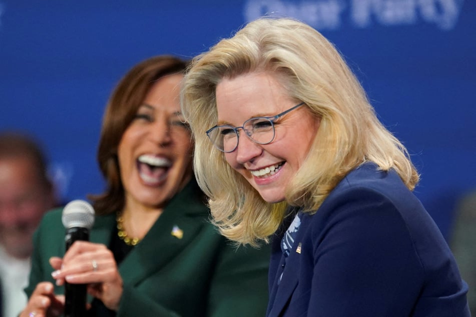 Democratic presidential nominee Kamala Harris (l.) and former Congresswoman Liz Cheney laugh together during a conversation moderated by Charlie Sykes in Brookfield, Wisconsin.