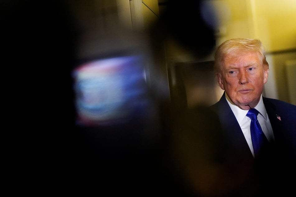 President Donald Trump speaks to reporters onboard Air Force One as he travels from West Palm Beach, Florida, to Joint Base Andrews, Maryland, on February 16, 2026.