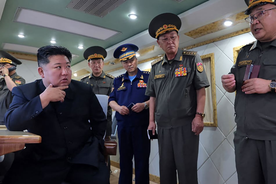 North Korean leader Kim Jong Un (l.) oversaw Saturday's test launch of two new air defense missiles as tensions escalate with the South.