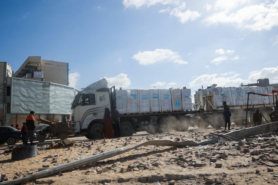 Minutes after the truce began, the United Nations said the first trucks carrying desperately needed humanitarian aid had entered the Palestinian territory.