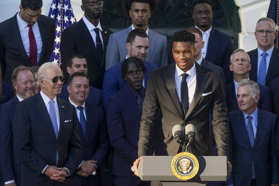 President Joe Biden looks on as Bucks star Giannis Antetokounmpo speaks about the winning the 2021 NBA Championship.