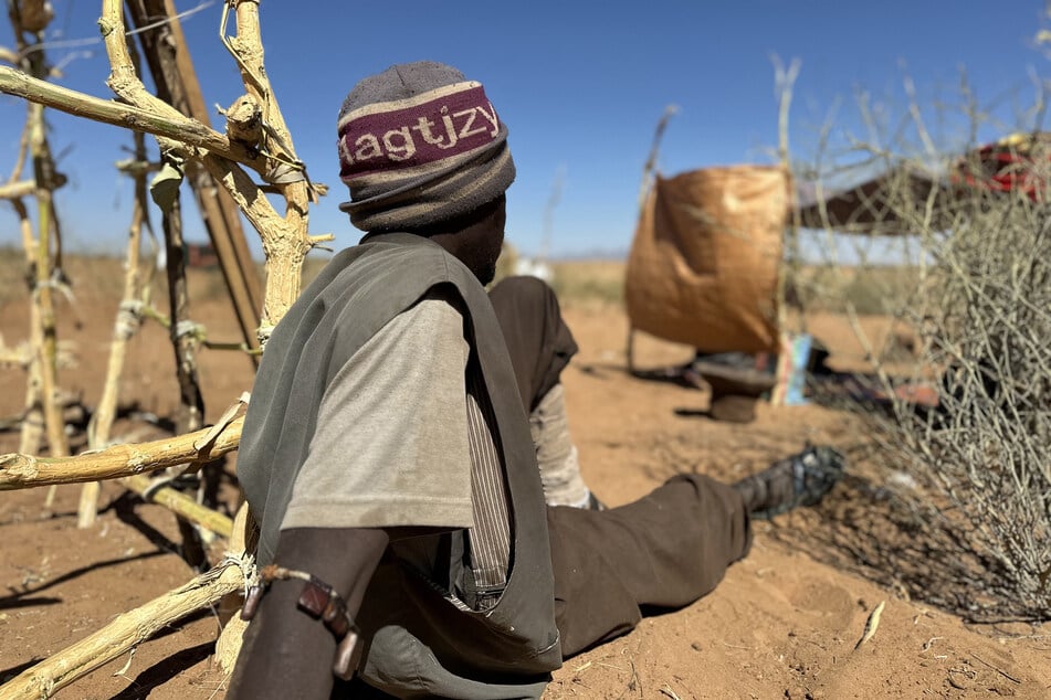 Abdullah Idris sits at a makeshift shelter in the Sudanese town of Tawila on March 2, 2026.