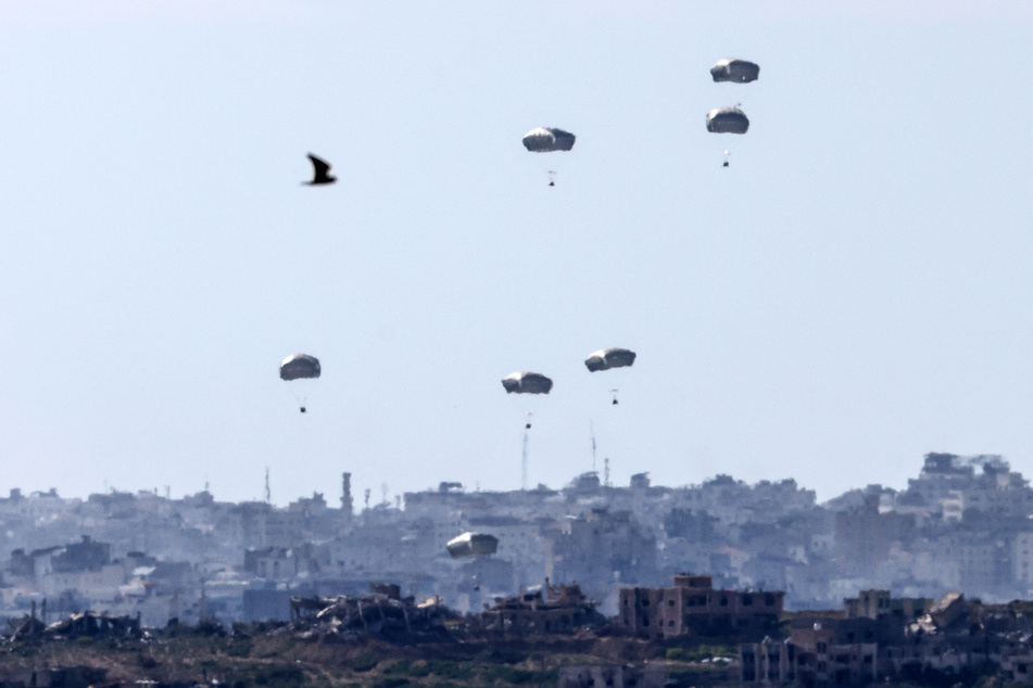 Picture taken from Israel's southern border with the Gaza Strip shows humanitarian aid being airdropped over the Palestinian territory on Sunday.