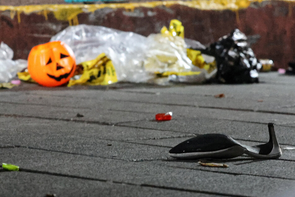 A shoe and a plastic Halloween pumpkin are pictured at the scene where a stampede killed and injured many people during festivities in the popular Itaewon district of Seoul, South Korea.