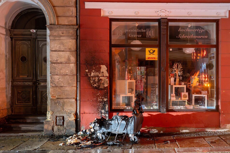 Die Flammen griffen auch auf das nahestehende Gebäude über. Auch die Fassade des Hauses musste gelöscht werden.
