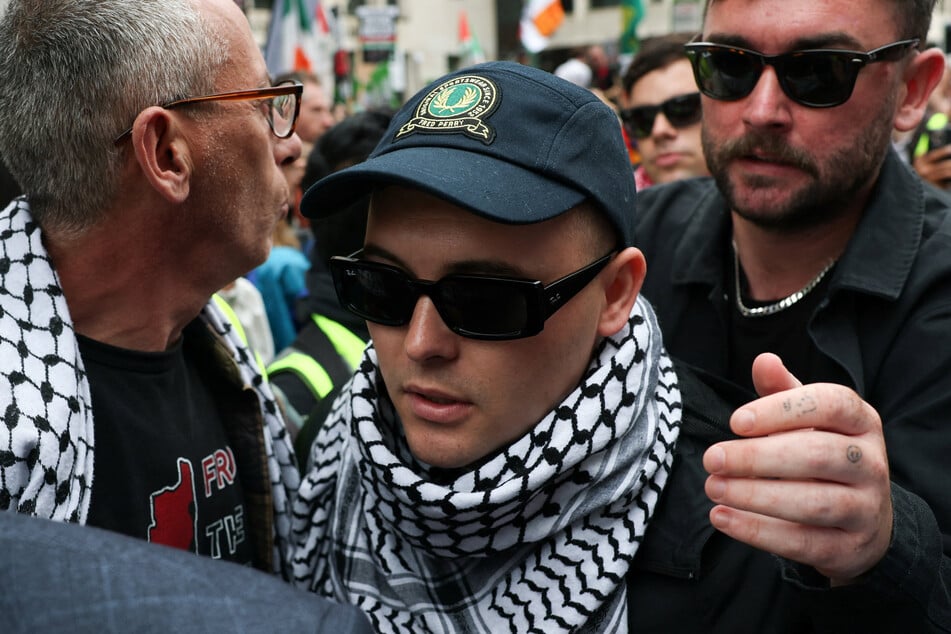 Kneecap member Liam O'Hanna, also known as Liam Og O hAnnaidh and performing under the name of Mo Chara, walks outside the Westminster Magistrates' Court in London on August 20, 2025.