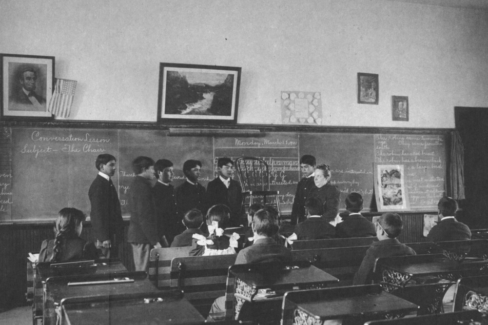 Indigenous children stolen from their families are forced to take English conversation lessons at Carlisle Indian Industrial School.