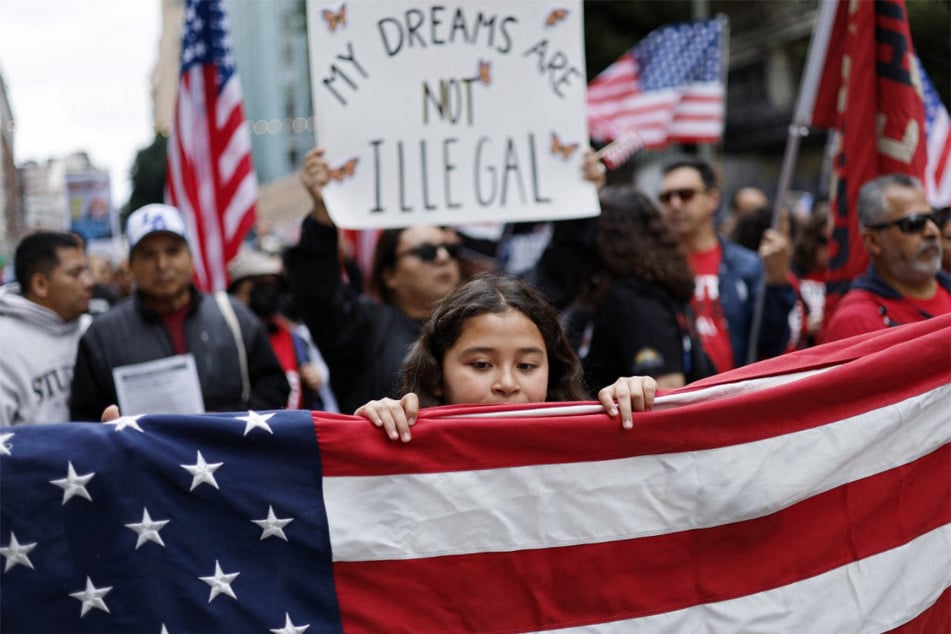 A demonstrator carries a sign reading "My Dreams Are Not Illegal" as immigrants' rights supporters participate in a "March for Dignity" in Los Angeles, California.