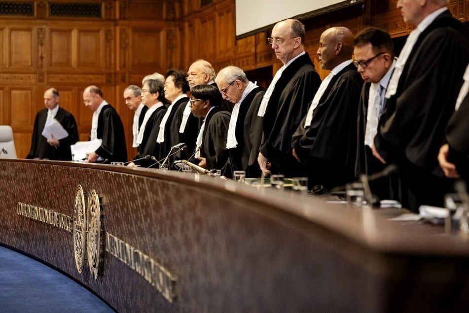 Judges rise during a hearing at the International Court of Justice, as part of the proceedings aiming to set a legal framework on how countries should tackle climate change.