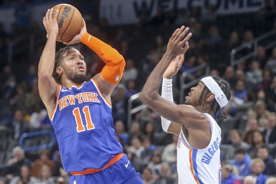 Jalen Brunson of the New York Knicks shoots over Shai Gilgeous-Alexander of the Oklahoma City Thunder during the third quarter at Paycom Center.