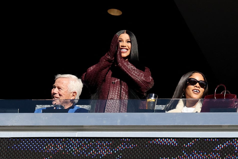 Cardi B (c.) sat next to New England Patriots owner Robert Kraft (l.) as she cheered on her boyfriend at his Sunday game.