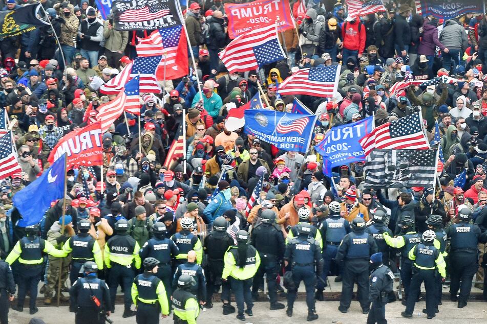 Donald Trump supporters clashing with police and security forces as they storm the US Capitol in Washington, DC on January 6, 2021.