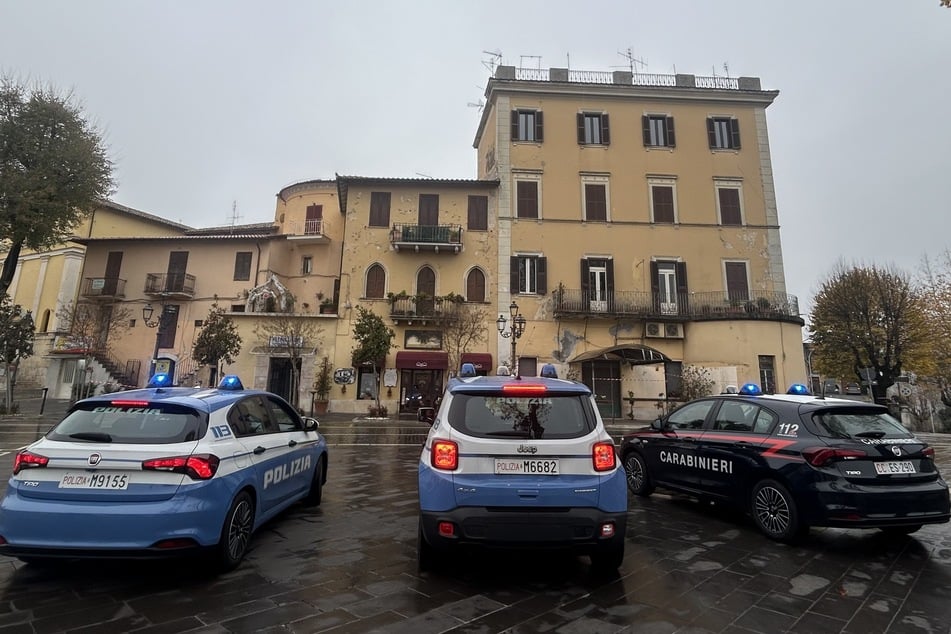 Three "Carabinieri" cars in front of a building in Bologna. The city has a strong right-wing scene.