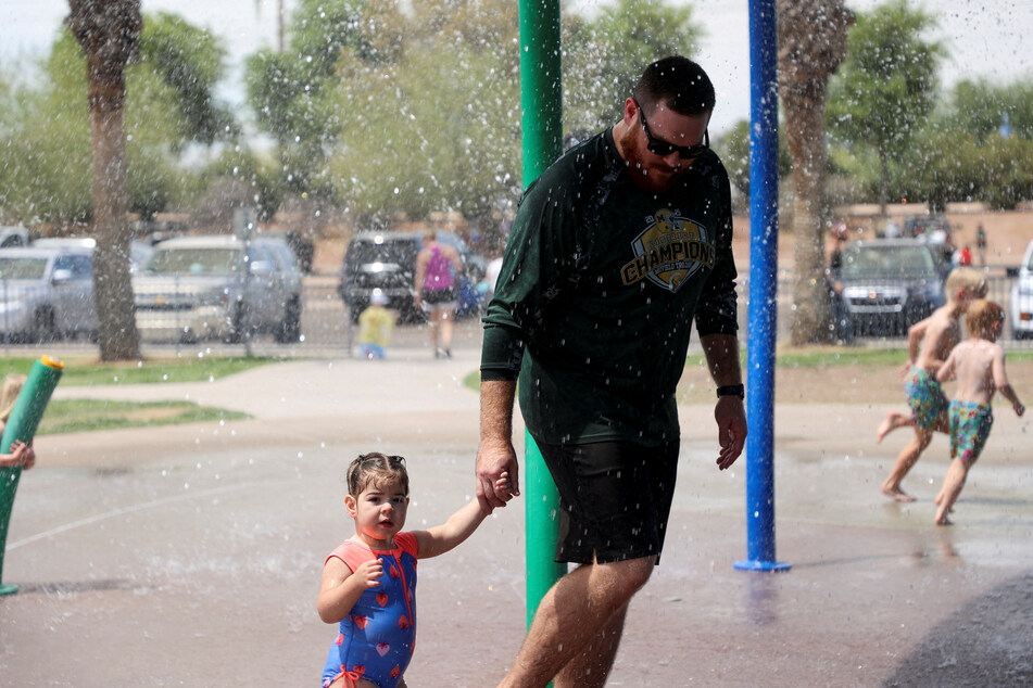 People cool off at a water park during a heat wave in Phoenix, Arizona.