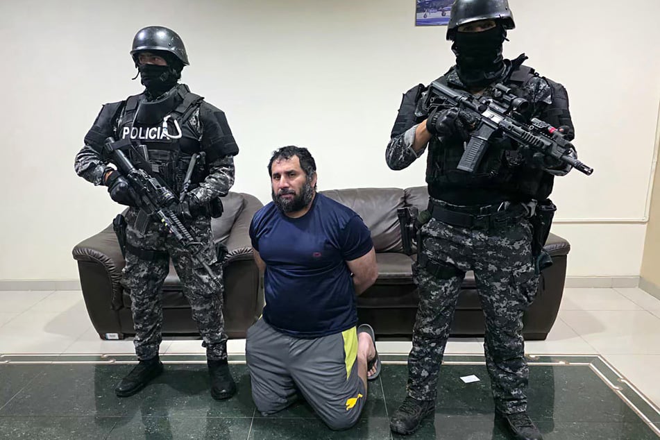 Adolfo Macias (c.), alias Fito, is guarded after his recapture in Manta, Manabi Province, Ecuador, on June 25, 2025.