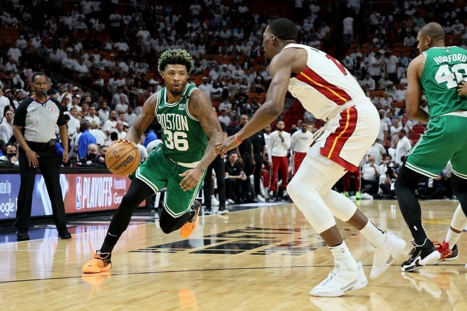 NBA Defense Player of the Year Marcus Smart of the Boston Celtics drives to the basket in Game Seven of the 2022 NBA Playoffs' Eastern Conference Finals.