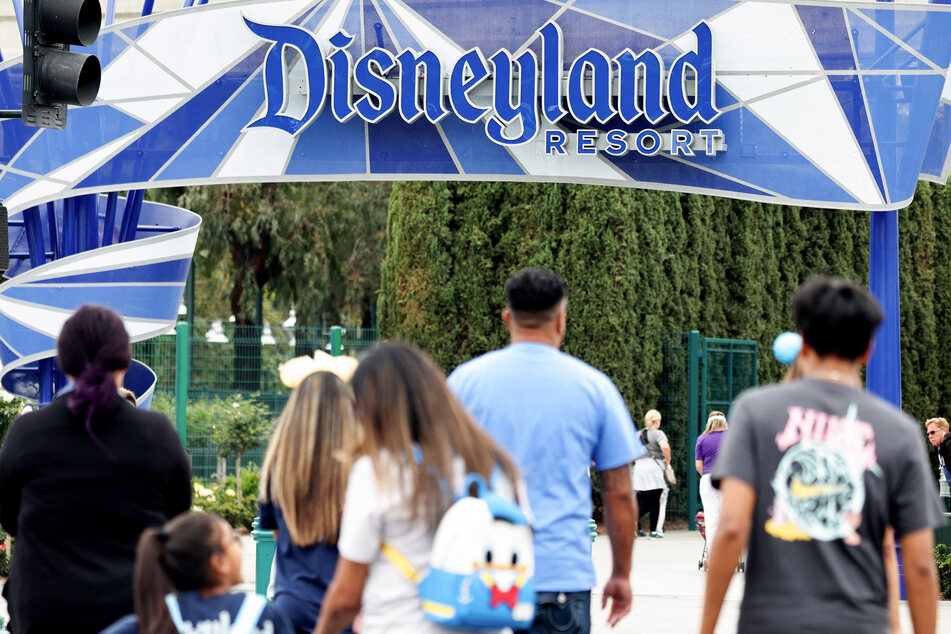 People walk toward an entrance to Disneyland on April 24, 2023 in Anaheim, California.