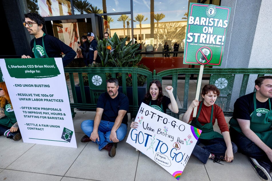 Starbucks baristas rally outside the company's corporate offices in Newport Beach, California, on November 24, 2025.
