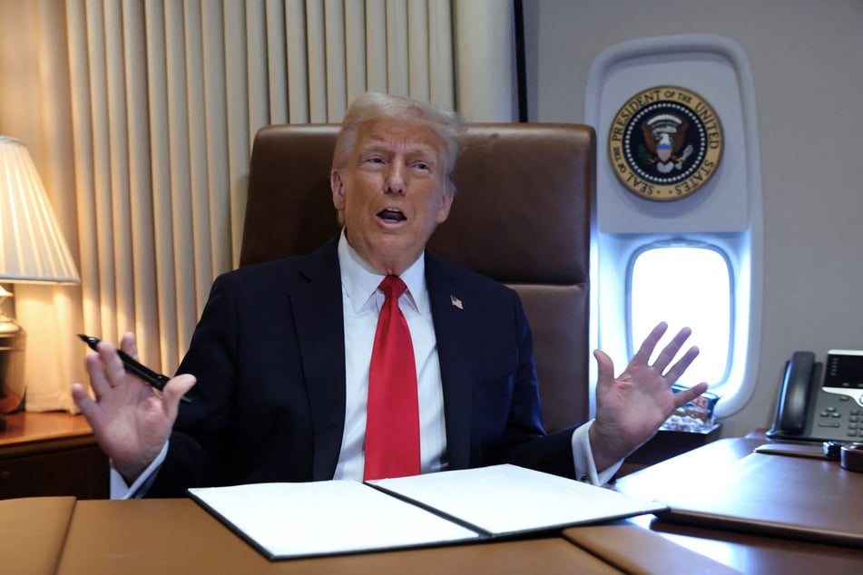 President Donald Trump speaks to reporters aboard Air Force One en route to New Orleans to attend the Super Bowl on February 9, 2025.